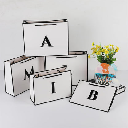 STOBOCTER Initial Gift Bags with Handles and Bow Ribbon 11"x8" Personalized Letter Gift Bags Birthday Gift Bag for Women Men Reusable Gift Wrap Bag for Mothers Day Wedding Graduation (J-Small)
